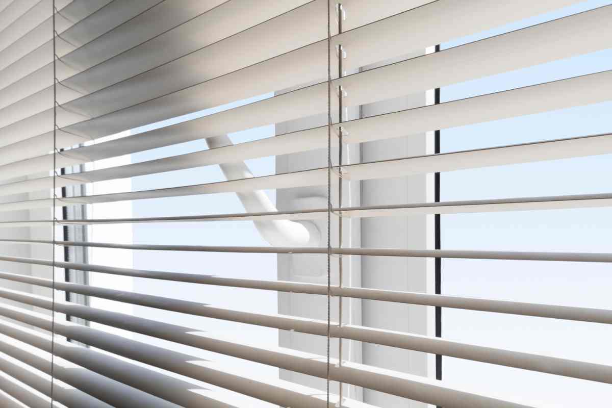 White window blinds covering a patio door at Vignettes Home near Galena, IL, and Dubuque, IA