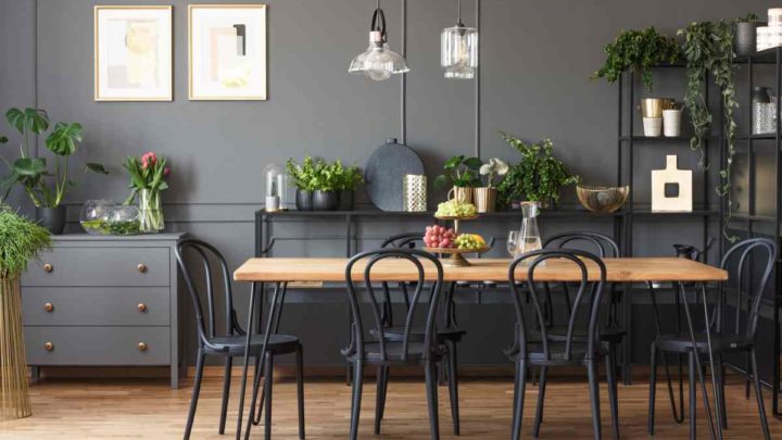 Dining room table with 6 chairs in a modern dining room with wall art, plants, and accessories at Vignettes Home near Galena, IL, and Dubuque, IA