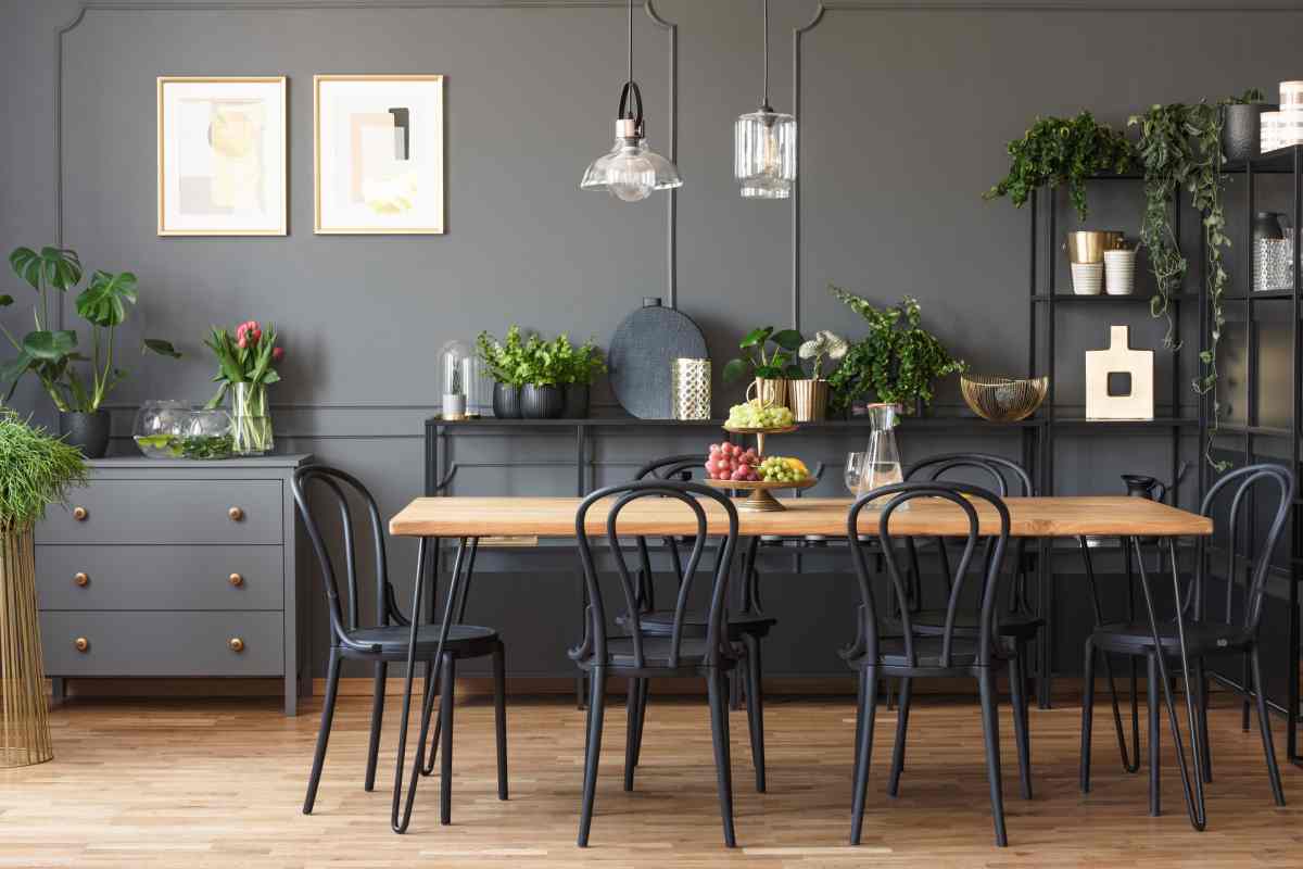 Dining room table with 6 chairs in a modern dining room with wall art, plants, and accessories at Vignettes Home near Galena, IL, and Dubuque, IA